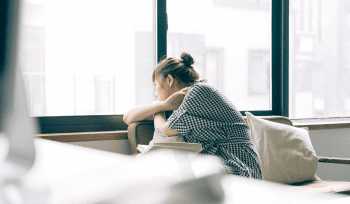 woman looking out window | separation under one roof | advocate lawyers