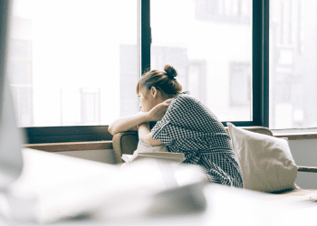 woman looking out window | separation under one roof | advocate lawyers
